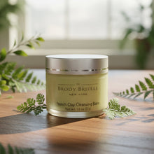 Load image into Gallery viewer, Closed Jar of Brody Brielle French Clay Cleansing Balm on a wooden surface with greenery in the background