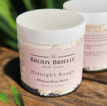Load image into Gallery viewer, Jar of Brody Brielle Midnight Rouge Whipped Body Butter on a wooden surface with greenery in the background.
