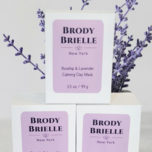 Load image into Gallery viewer, Three boxes of Brody Brielle Rosehip + Lavender Face Mask with lavender sprigs on a white background
