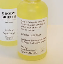 Load image into Gallery viewer, Yellow squalane Super Glow serum bottle with back label on a white background

